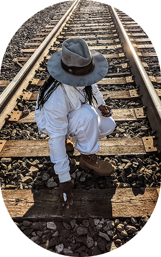 hand on railroad tracks